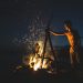 topless man lighting bonfire